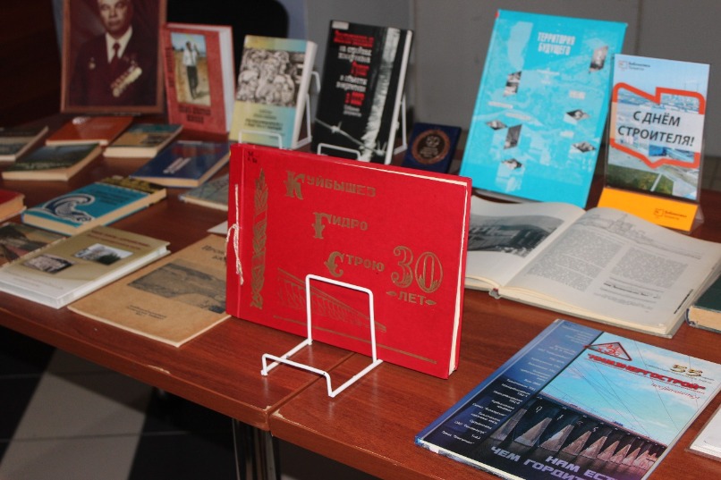 На входе гостей праздника по случаю Дня строителя встречала выставка книг и газет, в которых отпечатался трудовой подвиг всех, кто возводил ВАЗ, ГЭС и химзаводы в Тольятти.